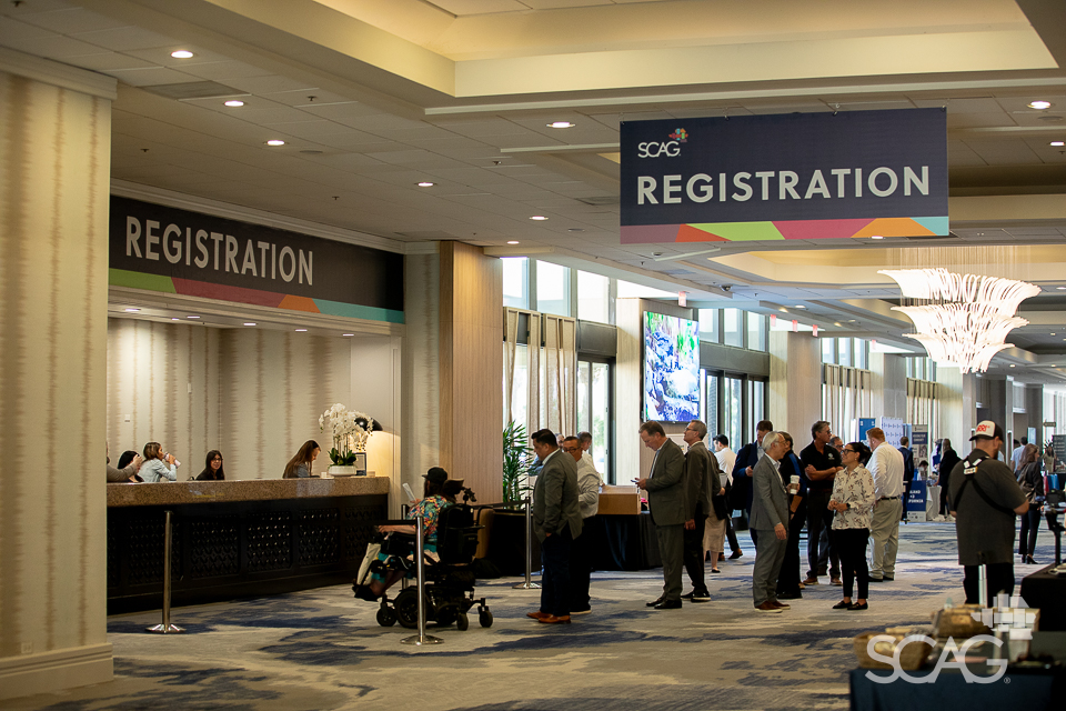 GA26 Conference registration area with people at the counter.
