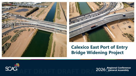 Aerial view of a widened bridge over a canal in a desert landscape.